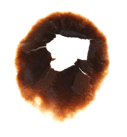 A burnt spot on a white background. The burnt spot is in the shape of a face. The burnt spot is brown and has a smoky appearanceの写真素材