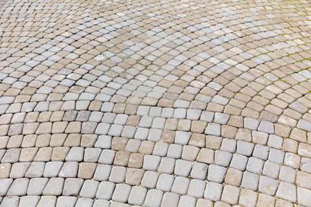 A gray and white brick patterned walkway. The pattern is made up of many small squaresの写真素材
