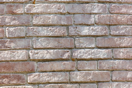 A brick wall with a white border. The wall is made of red bricks and has a white borderの写真素材
