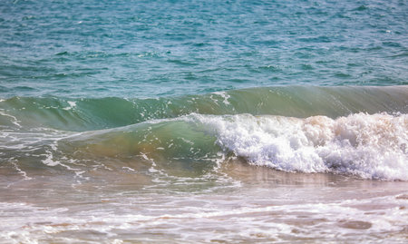 The ocean is calm and the water is a beautiful shade of blue. The waves are small and gentle,...
