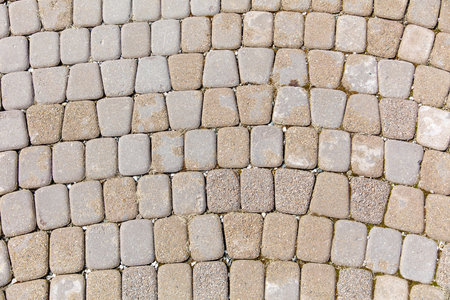 A brick patterned floor with a gray and tan color scheme. The pattern is made up of small square tilesの写真素材