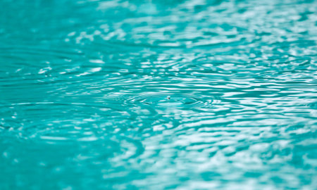 The water is calm and clear, with ripples forming around a small object. Concept of tranquility and...