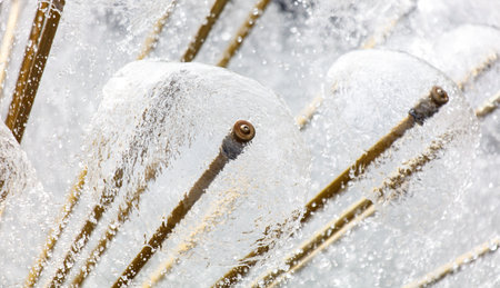 A frozen landscape with a large number of small, frozen water droplets. The droplets are scattered throughout the scene, with some appearing to be frozen in mid-air and others resting on the groundの写真素材