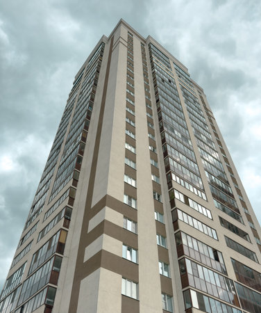 A tall building with a lot of windows and a cloudy sky in the background. The building is very tall...