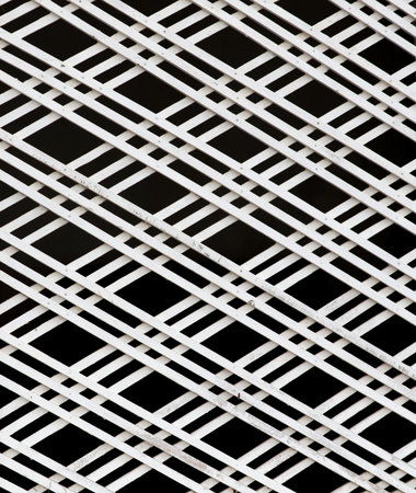 A white and black striped patterned background. The pattern is made up of white squares
