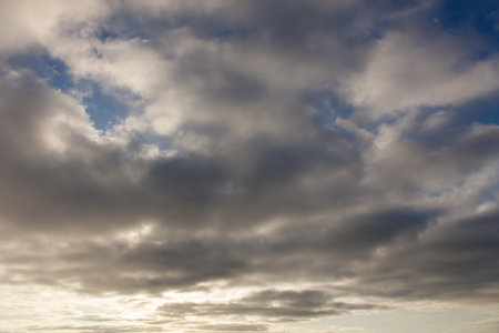 The sky is filled with clouds, but the sun is still shining through, creating a serene and peaceful...