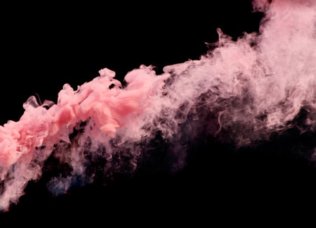 A vibrant pink smoke is rising from a fire, creating a dramatic and intense atmosphere. The smoke is thick and billowing, filling the air with a sense of urgency and dangerの写真素材