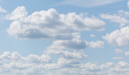 A blue sky with many clouds. The clouds are white and scattered throughout the sky. The sky is clear...