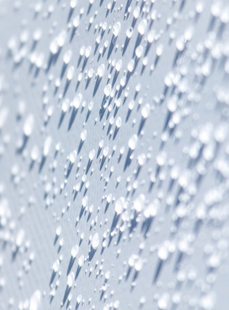 A close up of a wet surface with many small droplets of water. The droplets are scattered all over...