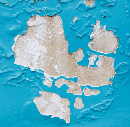 A blue wall with white paint peeling off. The wall is in the shape of a heartの写真素材