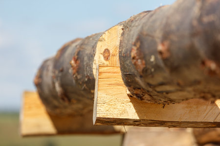A wooden beam is on the roof of a building. The beam is made of wood and is brown in colorの写真素材