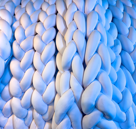 The rope is made of white and blue material. It is twisted and knotted, creating a unique and intricate pattern. The rope is long and stretches across the entire imageの写真素材