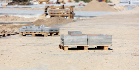 A pile of bricks on a pallet. There are several pallets of bricks. The bricks are stacked on top of each otherの写真素材