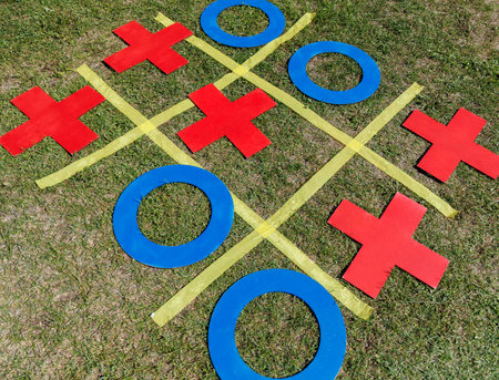 A tic-tac-toe board with red and blue squares. The squares are in the shape of a cross.