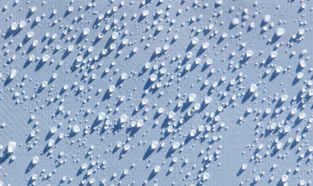 A close up of a wet surface with many small droplets of water. The droplets are scattered all over...