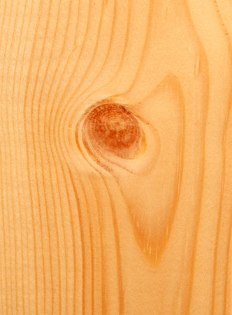A piece of wood with a hole in the center. The hole is brown in colorの写真素材