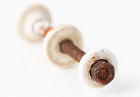 A rusty bolt is on a white surface. The bolt is missing its headの写真素材