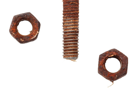 A bolt is shown with a nut on top of it. The nut is missing. The bolt is rustyの写真素材