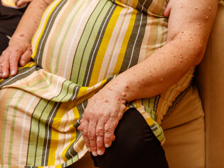 A woman with a green and yellow striped dress is sitting on a couch.の写真素材