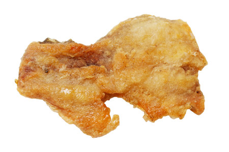 A piece of fried food with a white background. It is a piece of fried chicken. The chicken is golden brown and has a crispy textureの写真素材