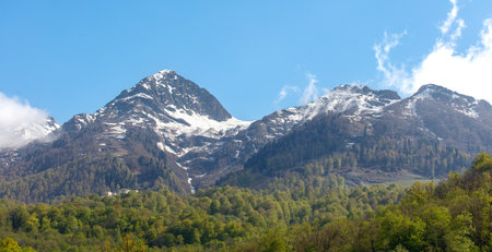 The mountains are covered in snow and the sky is clear. The view is breathtaking and serene