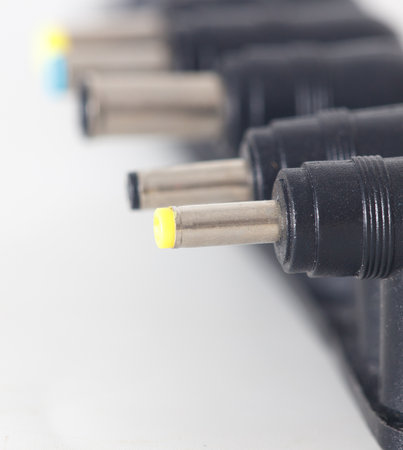 A row of black and yellow plugs. The yellow plugs are the ones that are plugged in