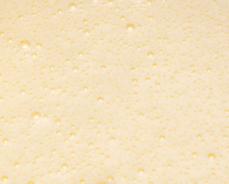 A white background with many small bubbles. The bubbles are scattered all over the background. The bubbles are of different sizes and shapesの写真素材