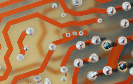 Close up of orange electronic computer circuit board as background.