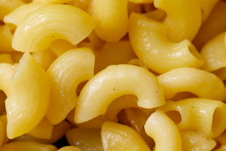 A pile of yellow pasta. The pasta is long and thin