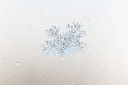 Frost pattern on window glass as background.