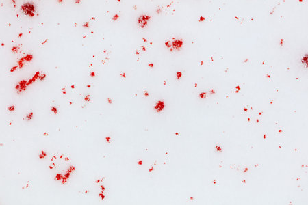 Red drops of blood on white snow as a background.の写真素材