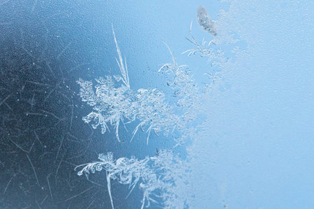 Frost pattern on window glass as background.