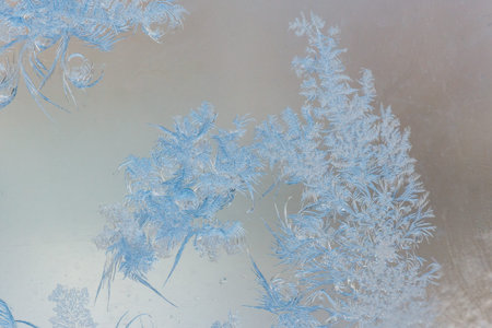 Frost pattern on window glass as background.