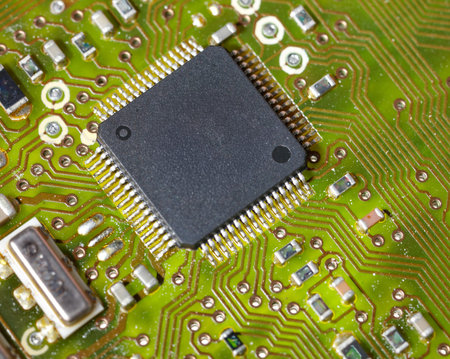Close-up of a green electronic computer board with microchips.