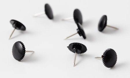 Sharp black button rivets on white background.