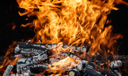 A pile of wood with a lot of fire and smoke coming from it. The fire is very hot and the smoke is...