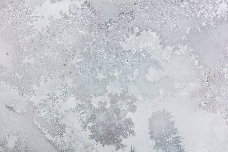 Frost pattern on window glass as background.