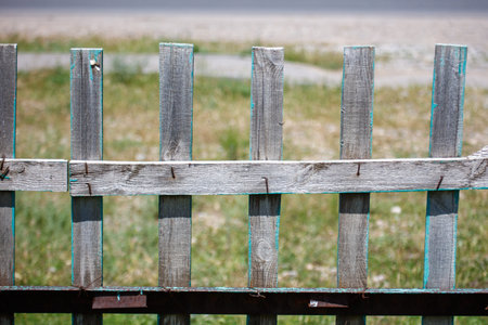 Old wooden fence on the field. Selective focus. Toned.