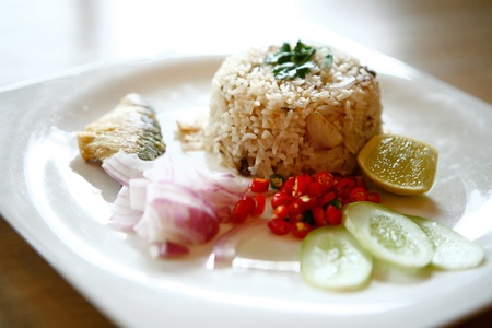 Fried rice with salt fish on white plateの写真素材