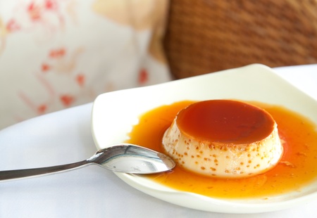Caramel Custard on white dishの写真素材