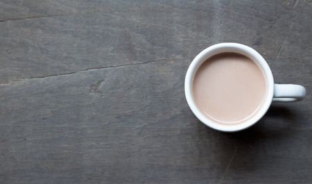 A white cup of hot cocoa on wood backgroundの写真素材