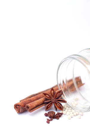 cinnamon sticks with anise star and white peppers on white backgroundの写真素材