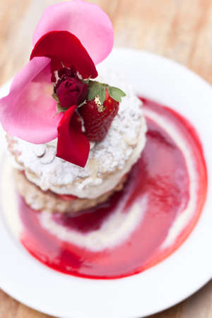 delicious strawberry short cake with beautiful topping on white plateの写真素材