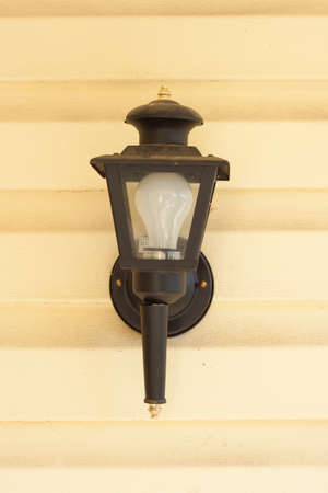 vintage wall lamp on yellow wallの写真素材