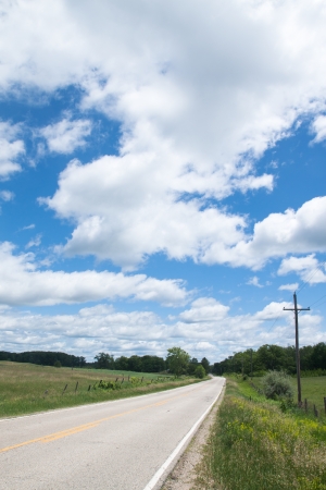 Country road in a cloudy day and blue skyの写真素材