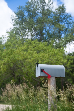 Rural mailbox on an old wooden stand on the country roadの写真素材