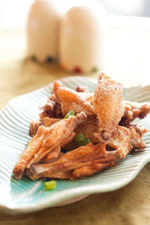 Thai style fried chicken wings on green tableの写真素材