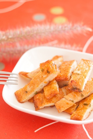 fried fish cakes on white plate on red backgroundの写真素材