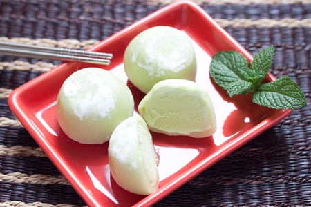 Green tea mochi ice cream on red plateの写真素材