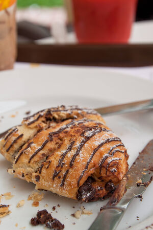 Chocolate croissant after eaten on white plateの写真素材